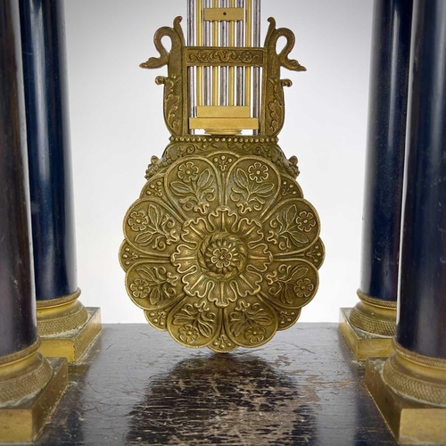 1709 - A French ebonised and ormolu portico clock. 19th century, with gilt capped tapered column supports, ... 