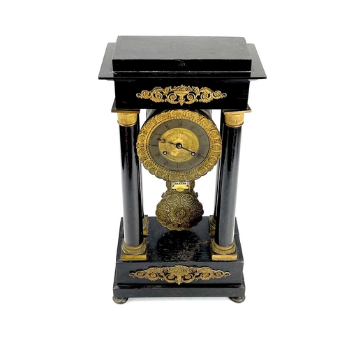 1709 - A French ebonised and ormolu portico clock. 19th century, with gilt capped tapered column supports, ... 