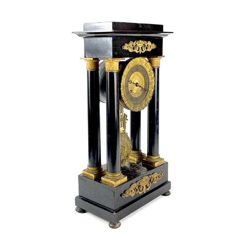 1709 - A French ebonised and ormolu portico clock. 19th century, with gilt capped tapered column supports, ... 