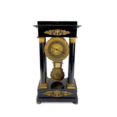 1709 - A French ebonised and ormolu portico clock. 19th century, with gilt capped tapered column supports, ... 