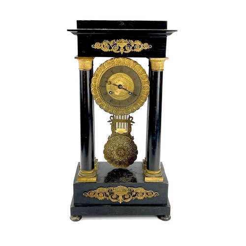 1709 - A French ebonised and ormolu portico clock. 19th century, with gilt capped tapered column supports, ... 