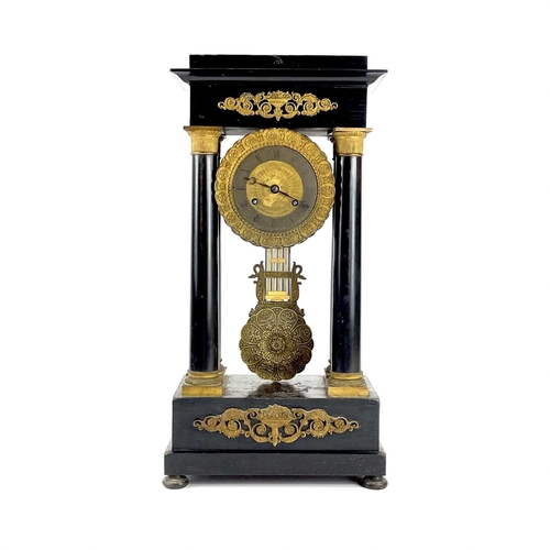 1709 - A French ebonised and ormolu portico clock. 19th century, with gilt capped tapered column supports, ... 