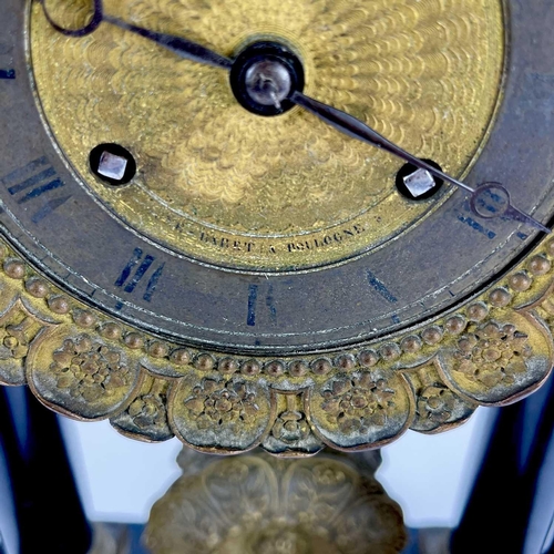 1709 - A French ebonised and ormolu portico clock. 19th century, with gilt capped tapered column supports, ... 