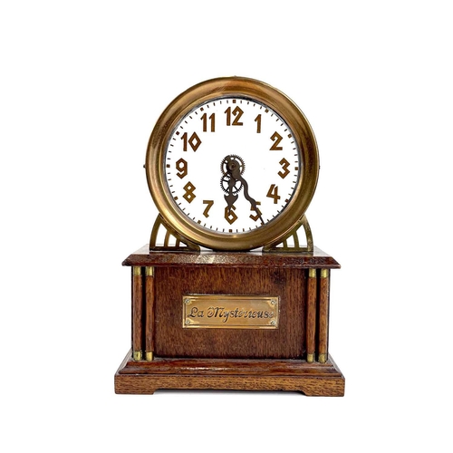 1713 - An American La Mysterieuse oak and brass cased mystery mantel clock. Circa 1910, the glass dial with... 