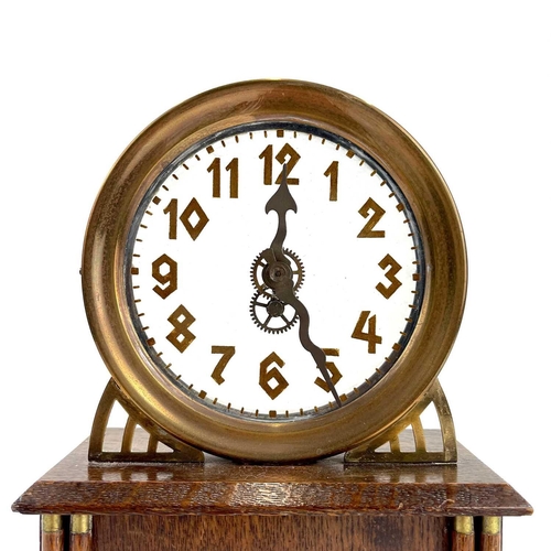 1713 - An American La Mysterieuse oak and brass cased mystery mantel clock. Circa 1910, the glass dial with... 