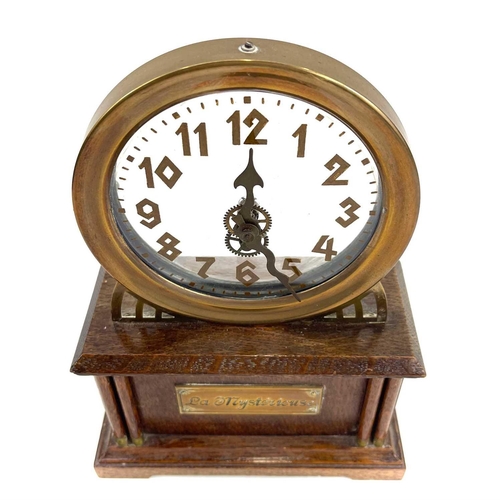 1713 - An American La Mysterieuse oak and brass cased mystery mantel clock. Circa 1910, the glass dial with... 