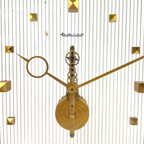 1716 - A Jaeger Le Coultre skeleton clock. With floating baguette movement and brushed brass case with gilt... 