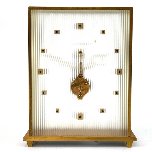 1716 - A Jaeger Le Coultre skeleton clock. With floating baguette movement and brushed brass case with gilt... 