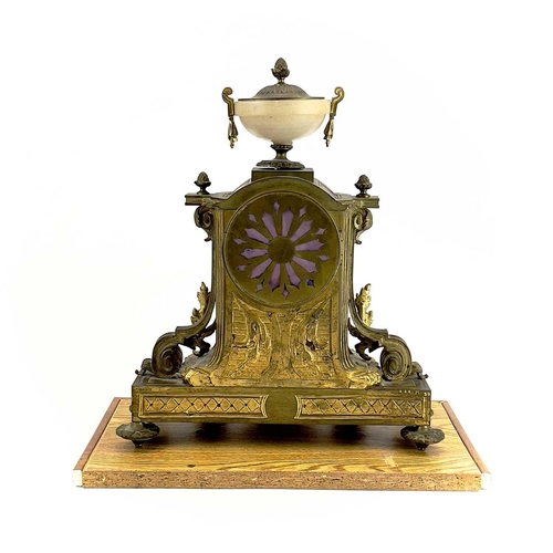 1718 - A French gilt metal and alabaster eight day mantel clock. In the Neo-Classical taste, with urn finia... 