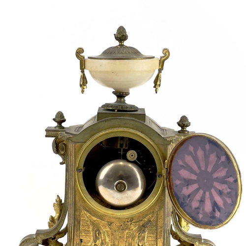 1718 - A French gilt metal and alabaster eight day mantel clock. In the Neo-Classical taste, with urn finia... 