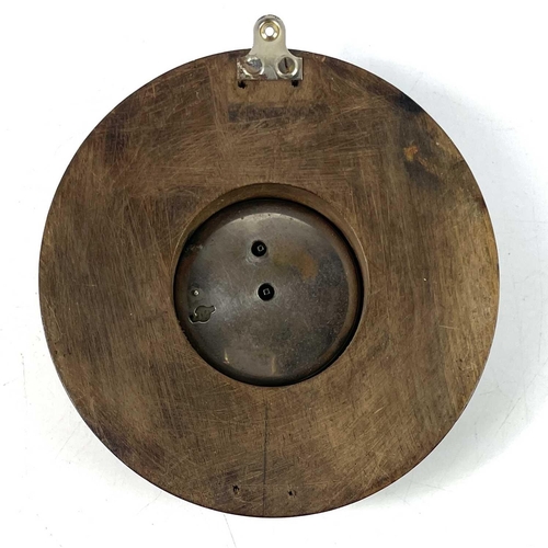 1721 - A Swiss eight-day car clock. The later turned walnut mount inscribed NAAFI, total diameter 14cm.