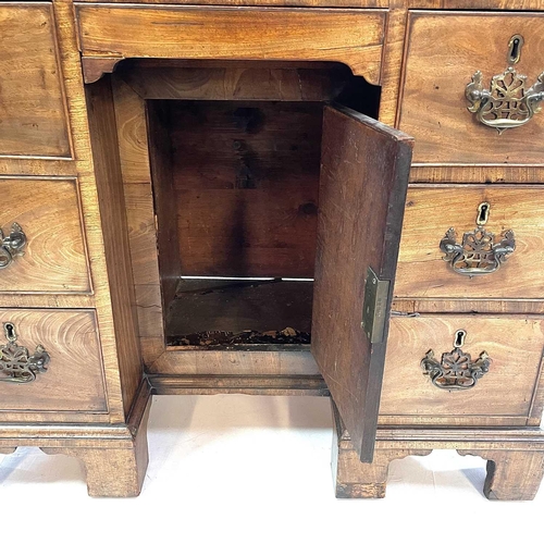 1802 - A George III mahogany kneehole gentleman's dressing table/writing desk. The rising top containing co... 