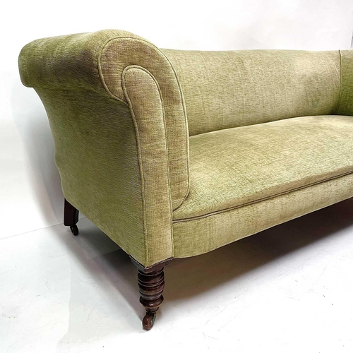 1815 - A Late Victorian upholstered four-seater settee. Raised on turned front legs and castors, height 73c... 