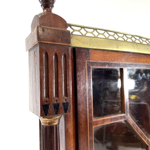 1816 - A Regency mahogany glazed hanging corner cupboard. With pierced brass gallery flanked by turned urns... 