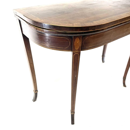 1818 - A George III mahogany and rosewood banded fold top card table. Raised on square taper legs with spla... 