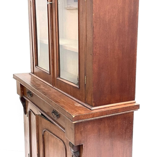 1820 - A Victorian mahogany two-part cabinet. The upper section with two glazed doors, the lower part fitte... 