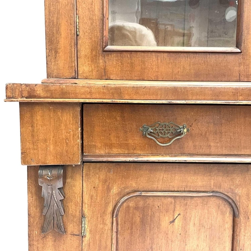 1820 - A Victorian mahogany two-part cabinet. The upper section with two glazed doors, the lower part fitte... 