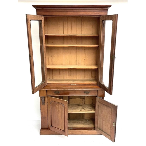 1820 - A Victorian mahogany two-part cabinet. The upper section with two glazed doors, the lower part fitte... 