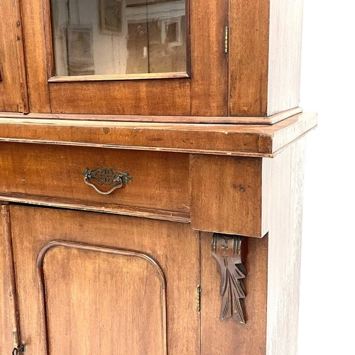 1820 - A Victorian mahogany two-part cabinet. The upper section with two glazed doors, the lower part fitte... 