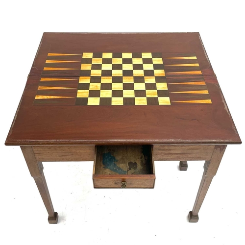 1823 - A George III mahogany and padouk games table. The folding top inlaid for chess and backgammon. fitte... 