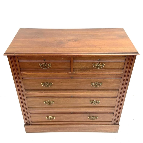 1826 - An Edwardian walnut chest. Fitted with two short and three long drawers with moulded fronts and on a... 