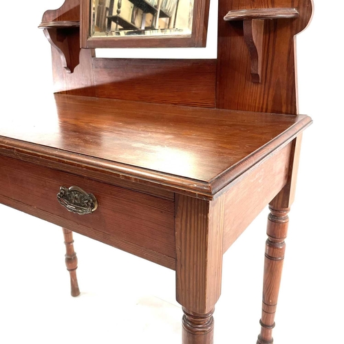 1829 - A late Victorian pitch pine dressing table. Fitted with a swing mirror above a long drawer and raise... 