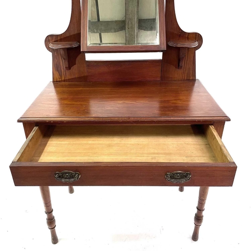 1829 - A late Victorian pitch pine dressing table. Fitted with a swing mirror above a long drawer and raise... 