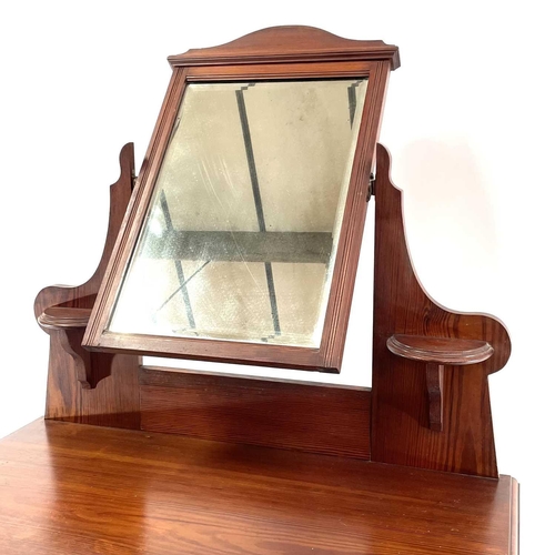 1829 - A late Victorian pitch pine dressing table. Fitted with a swing mirror above a long drawer and raise... 