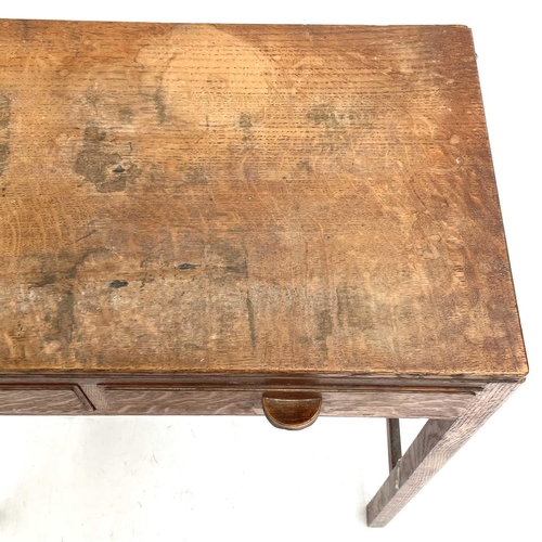 1833 - An oak Arts & Crafts side table. Fitted with two drawers and raised on square legs with stretchers. ... 