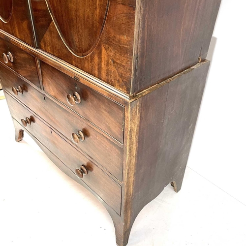 1836 - A George III mahogany linen press. The upper part with two oval panel doors enclosing sliding shelve... 