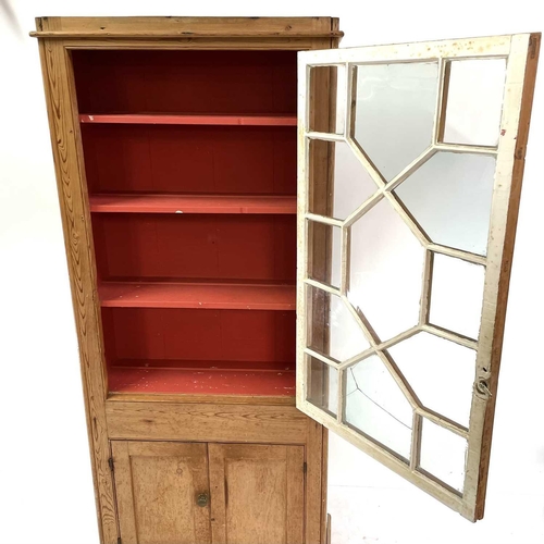 1842 - A Victorian pine display cabinet. The upper part with astragal glazed door enclosing three shelves, ... 