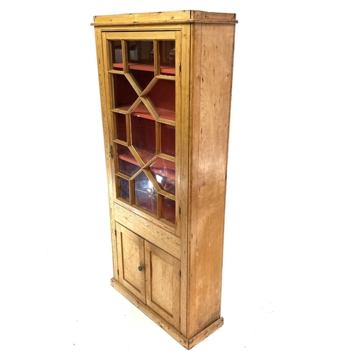 1842 - A Victorian pine display cabinet. The upper part with astragal glazed door enclosing three shelves, ... 