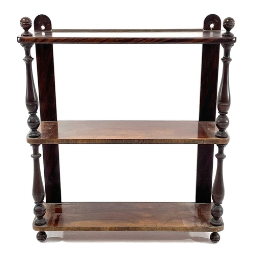 1851 - A Victorian rosewood and simulated rosewood wall shelf. The three shelves with baluster turned front... 