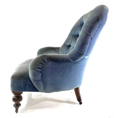 1852 - A Victorian walnut framed button back upholstered armchair. Raised on turned front legs and castors,... 