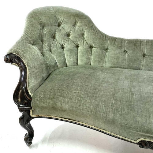 1853 - A late Victorian upholstered button back chaise lounge Walnut frame carved with scrolls on castor wh... 