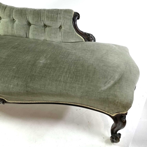 1853 - A late Victorian upholstered button back chaise lounge Walnut frame carved with scrolls on castor wh... 