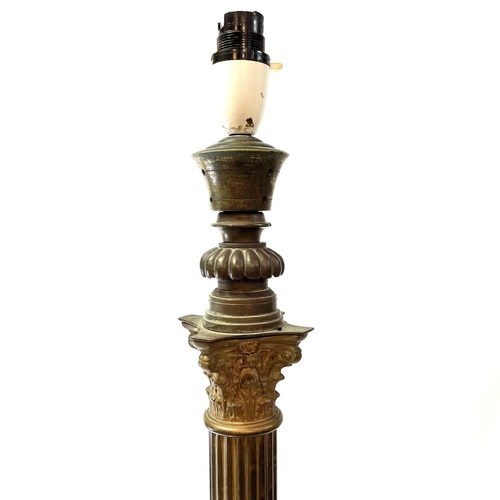 1854 - A Victorian brass Corinthian column lamp standard. Raised on a stepped square base, height 121cm, co... 