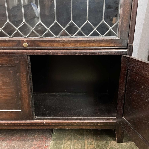 1860 - An oak glazed four part sectional bookcase. 2nd quarter 20th century, with lead glazed rising doors,... 