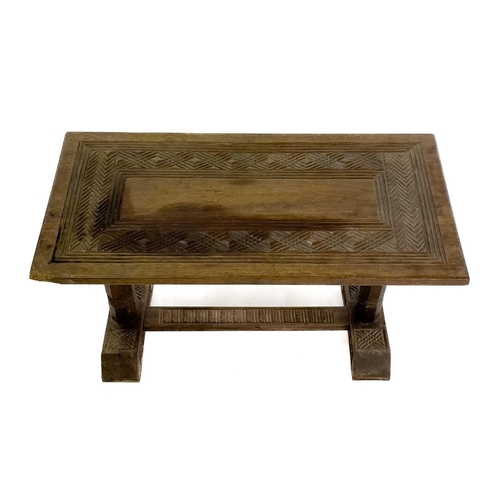 1864 - An African hardwood rectangular coffee table. Probably Nigeria, with carved geometric design to the ... 