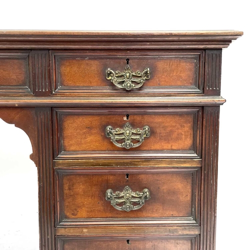 1867 - A late Victorian mahogany kneehole desk or dressing table. Fitted with one long and eight short draw... 