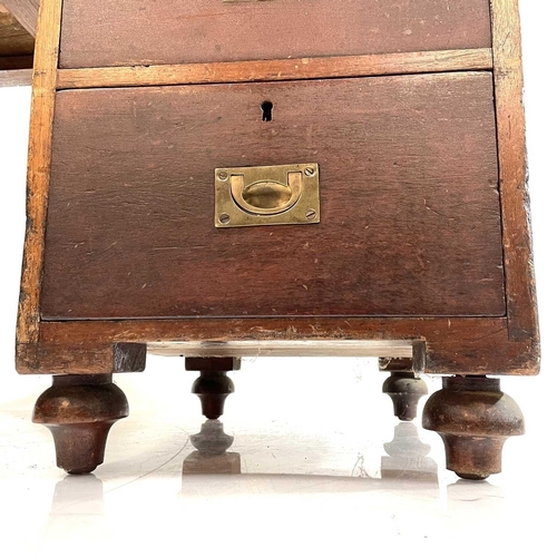 1878 - A late Victorian teak campaign style pedestal desk. With a tooled leather skiver and fitted with a s... 