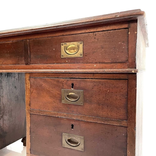 1878 - A late Victorian teak campaign style pedestal desk. With a tooled leather skiver and fitted with a s... 