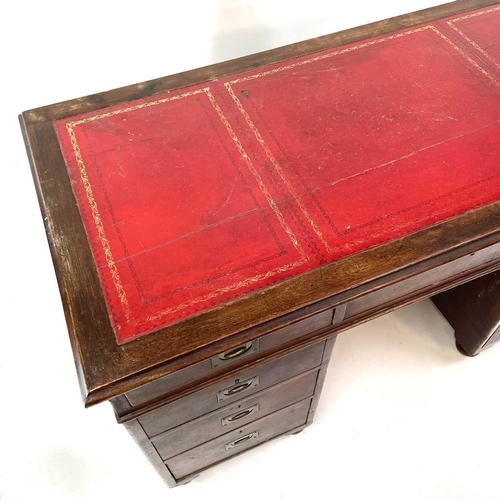 1878 - A late Victorian teak campaign style pedestal desk. With a tooled leather skiver and fitted with a s... 