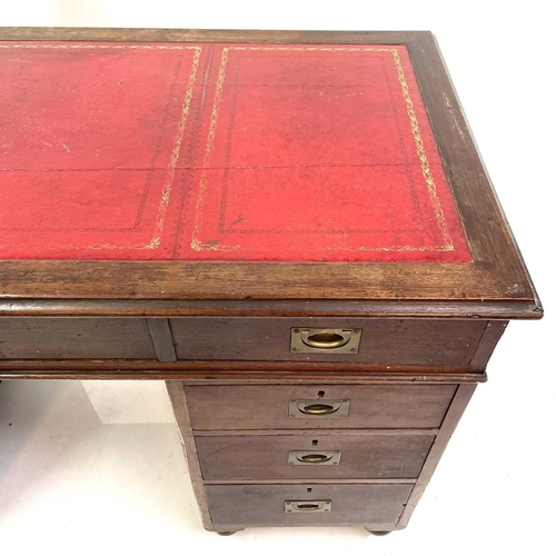 1878 - A late Victorian teak campaign style pedestal desk. With a tooled leather skiver and fitted with a s... 