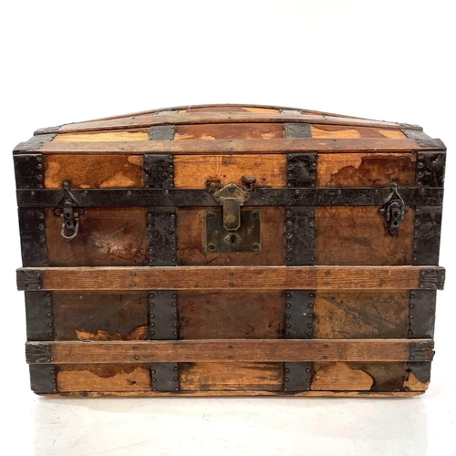 1881 - An oak and metal banded dome top trunk. Circa 1880, labelled for J.C.Sweeney, Newcastle-on-Tyne, hei... 