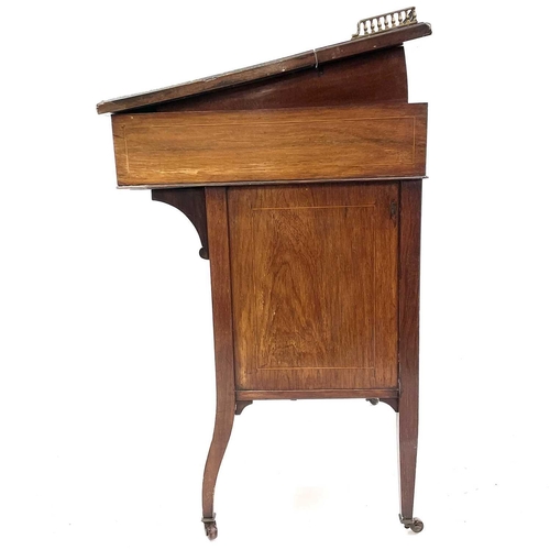 1883 - A late Victorian rosewood and inlaid Davenport desk. With a pierced brass three-quarter gallery abov... 