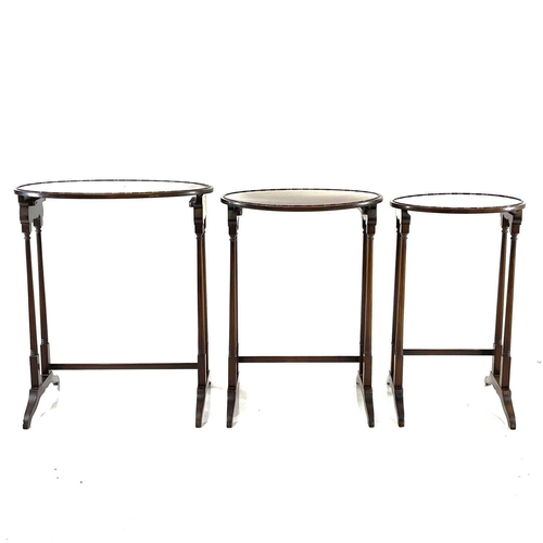 1884 - An Edwardian mahogany nest of three oval occasional tables. Raised on turned legs, the largest heigh... 