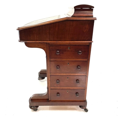 1885 - A Victorian mahogany Davenport desk stamped Jas Shoolbred & Co. With a sloping front before a statio... 