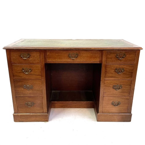 1890 - An Edwardian walnut kneehole desk. With tooled green leather skiver above one long and eight short d... 