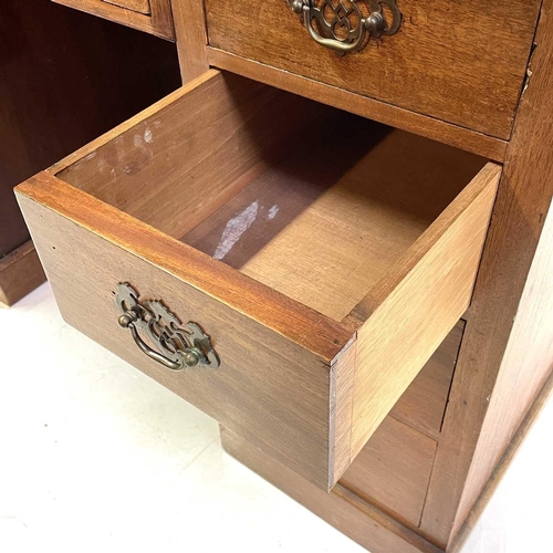 1890 - An Edwardian walnut kneehole desk. With tooled green leather skiver above one long and eight short d... 